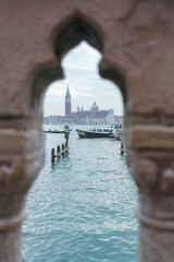 Scenic view of San Giorgio Maggiore island framed through decorative stone balustrade in Venice
