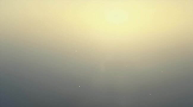 Subtle gradient background from yellowish to dark gray with blurred dust particles