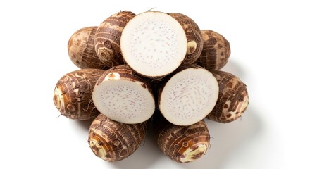 Obraz premium Pile of taro roots some whole and some cut in half revealing a lightcolored flesh with purple speckles