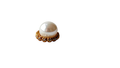 Fototapeta premium A lustrous pearl nestled within an ornate, golden band against a stark black backdrop