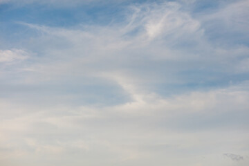A clear blue sky with a few clouds