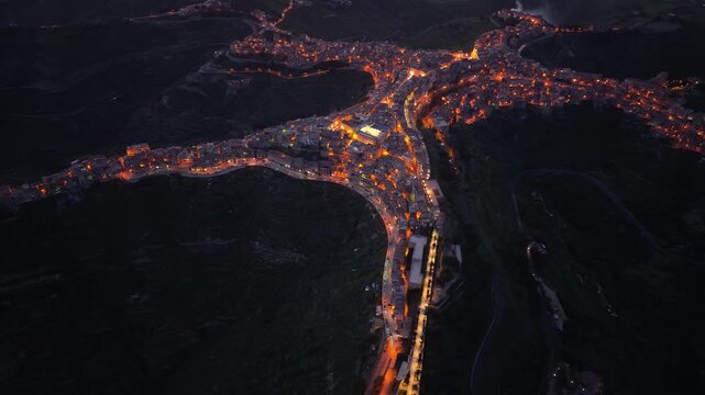 Illuminated star shaped Centuripe town aerial night view circling the Sicilian mountain community