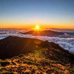 A serene mountain landscape at sunrise above clouds and greenery