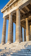 Naklejka premium Ancient Greek temple with tall, fluted columns and detailed entablature.