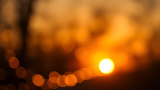 Soft glowing orbs of warm yellow light create a cozy and dreamy sunset ambiance.