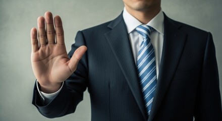 Obraz premium Person in formal attire signaling a stop with an open palm