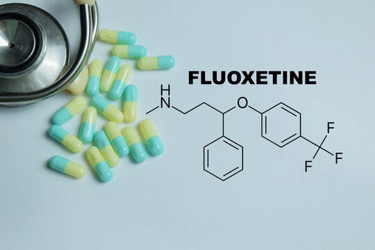 Concept of fluoxetine antidepressant write on book with isolated on Wooden Table. For depression anxiety and mental health therapy