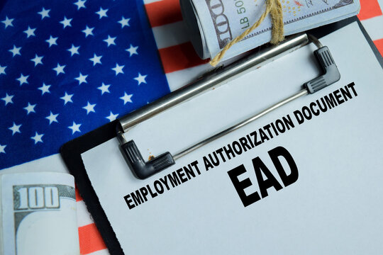 Concept of EAD - Employment Authorization Document write on clipboard isolated on Wooden Table. Showing legal right to work, immigration status, work permit and employment eligibility verification
