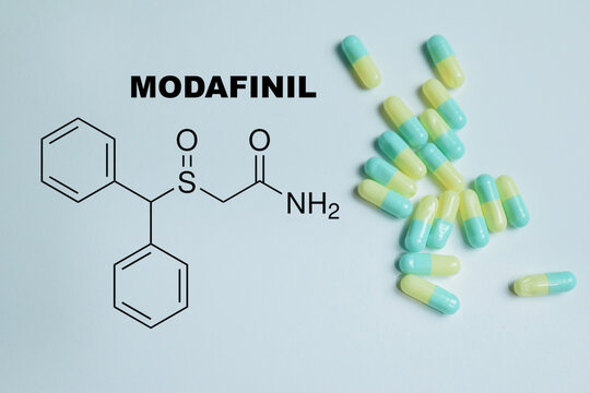 Concept of modafinil write on book with isolated on Wooden Table. Prescription wakefulness agent, cognitive performance and productivity in medical