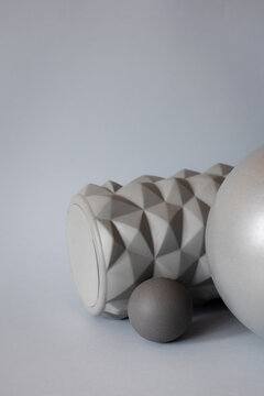 gray solid background for sports and fitness with copy space. mfr roll and massage ball for training