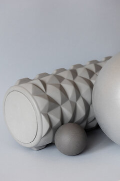gray solid background for sports and fitness with copy space. mfr roll and massage ball for training