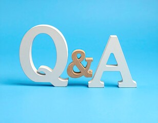 Large wooden letters "Q" and "A" with "&" symbol