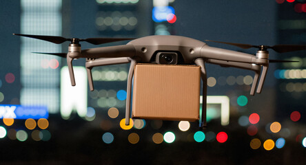 A delivery drone carries a cardboard box parcel