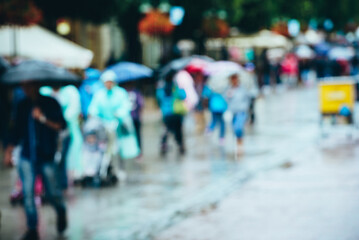 Obraz premium Pedestrians joyfully navigate puddles, sheltered by colorful umbrellas from the rain