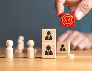 Hand adds target block to stacked figures on table