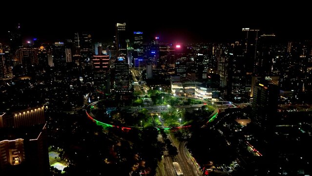 Jakarta, Indonesia, Dec 31, 2025 : Night cityscape of Jakarta near the Semanggi area, featuring tall buildings, glowing city lights, and busy urban roads.