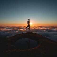 Woman doing yoga tree pose on mountain peak above clouds at sunset sunrise
