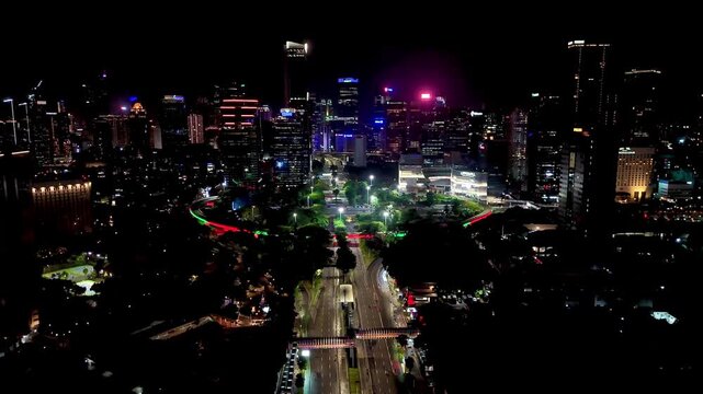 Jakarta, Indonesia, Dec 31, 2025 : Night cityscape of Jakarta near the Semanggi area, featuring tall buildings, glowing city lights, and busy urban roads.