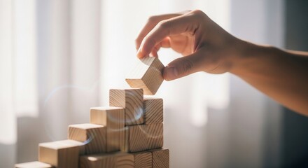 Hand Building Wooden Blocks Stack Near Window.