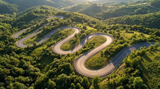 Winding mountain road aerial view lush green forest travel adventure