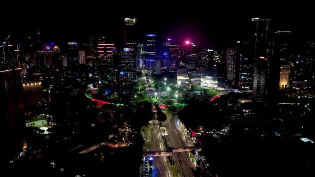 Jakarta, Indonesia, Dec 31, 2025 : Night cityscape of Jakarta near the Semanggi area, featuring tall buildings, glowing city lights, and busy urban roads.