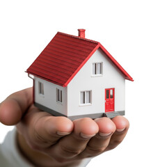Hand holding a small model house with a red roof and white walls isolated on transparent background