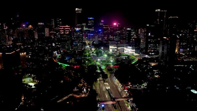 Jakarta, Indonesia, Dec 31, 2025 : Night cityscape of Jakarta near the Semanggi area, featuring tall buildings, glowing city lights, and busy urban roads.