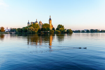 Fototapeta premium Sunrise view of the lake and the Schwerin Castle