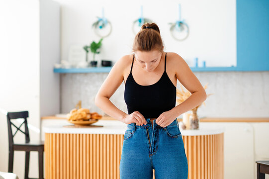 Cute Woman Zipping Up Jeans