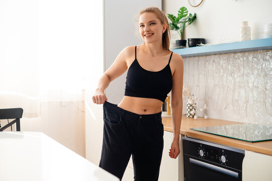 Woman Showing Weight Loss Success