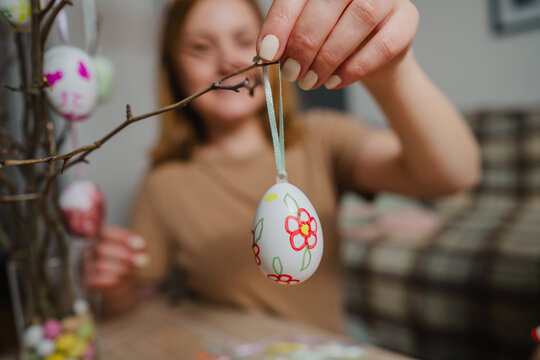 Decorating Easter egg on twig for holiday celebration at home
