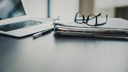 Office desk with laptop and documents