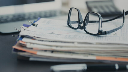 Office desk with laptop and documents