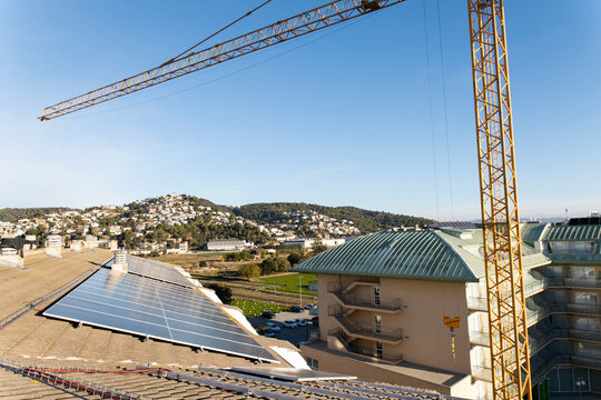 Solar panel rooftop and construction crane