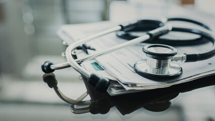 Medical data and stethoscope on table