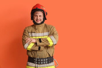 Male firefighter on orange background