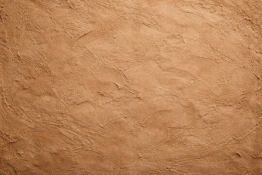 Tan Sandstone Plaster Wall Texture. Warm tan colored stucco wall with visible trowel marks and a tactile finish, suitable for Mediterranean or rustic interior design themes.