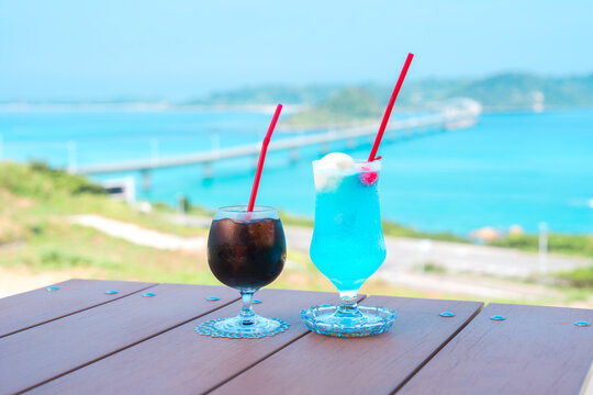 日本の山口県にある角島大橋を背景にしたアイスコーヒーとクリームソーダの飲み物