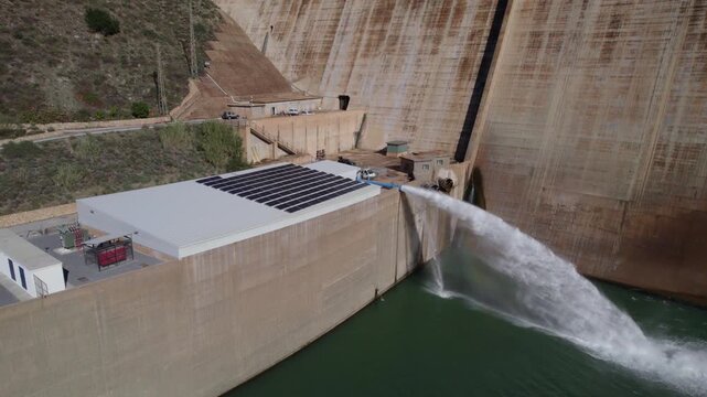 Water outlet from dam wall. Howell Bunger valve in operation. Pressurized water outlet from dam wall. Water flowing from pumping in reservoir. Hydropower station pumping water.