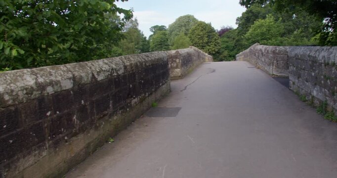 Wide panning shot looking on to devils bridge at Kirkby Lonsdale, North Yorkshire