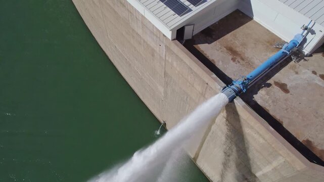 Howell Bunger valve in operation. Water outlet from dam wall. Pressurized water outlet from dam wall. Water flowing from pumping in reservoir. Hydropower station pumping water.
