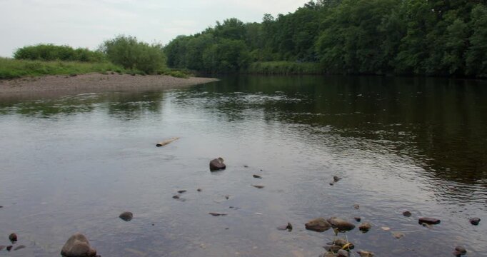 Wide shot looking down the river Lune with a rocky shoreline. at Brookhouse