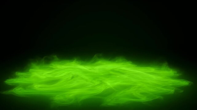 Eerie glowing green mist floating low to the ground in total darkness