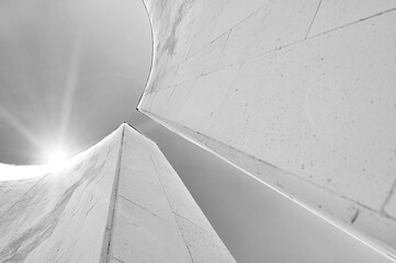 Semicircular concrete walls in futuristic urban style, lowest point of shooting. Futuristic architecture background with reflected lights over the concrete building details