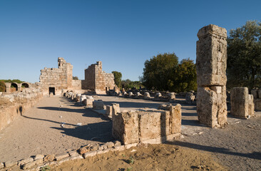 Fototapeta premium Ruins of the ancient city of Perge in Antalya. The columns of the Agora Square. Historical and archaeological heritage of Türkiye