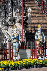 Separate fragments of a decorated Buddhist temple in Thailand on a sunny day