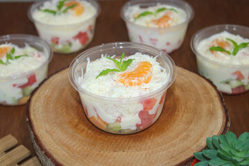 Healthy Creamy Fruit Salad with Grated Cheese and Orange Topping