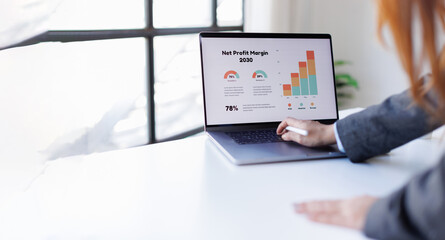 Accounting report spreadsheet. Business women using computer prepare business report for evaluation...