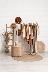 Interior of boutique with clothes rack, hats and ladder