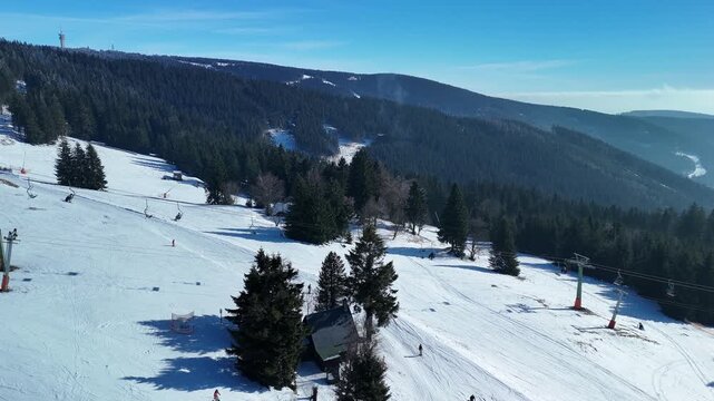 Drone Landscape Footage of Ski Resort With Snowboarders and Skiers on Mountain Slopes